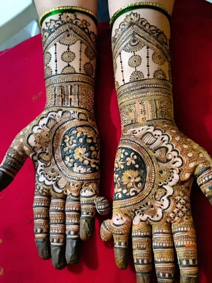 A unique bridal design featuring large, circular floral motifs on the palms. The initials 'H' and 'S' are subtly integrated into the wristband design.