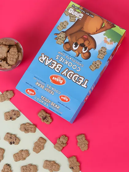 A colorful and graphic flatlay of the Teddy Bear Cookies. The diagonal composition and two tone background make it a visually engaging image for social media or online banners.