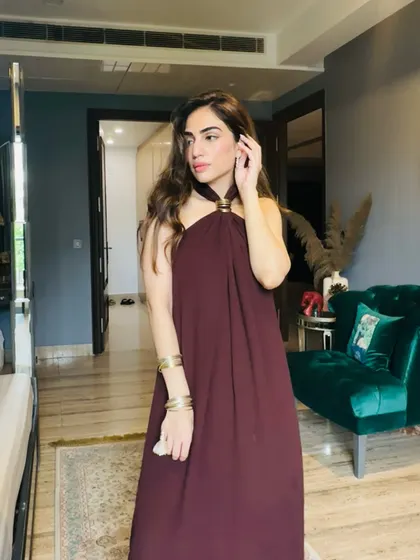 My Rakhi look in a simple yet elegant maroon halter-neck dress, accessorized with gold bangles.