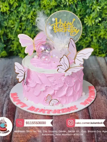 A delicate pink butterfly cake with feather and bubble accents. The soft textures and colours give this cake a dreamy and elegant feel.