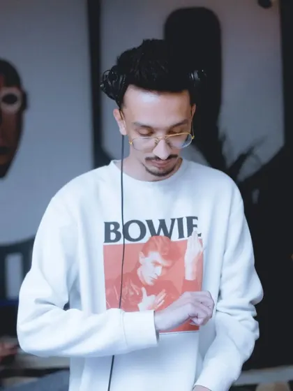 A DJ spinning tracks at one of our rooftop jams. I curate the entire music lineup, bringing in talented artists who know how to control the vibe.