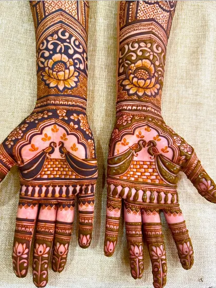A beautiful design for the back of the hands, featuring lotus and peacock motifs in a symmetrical layout.