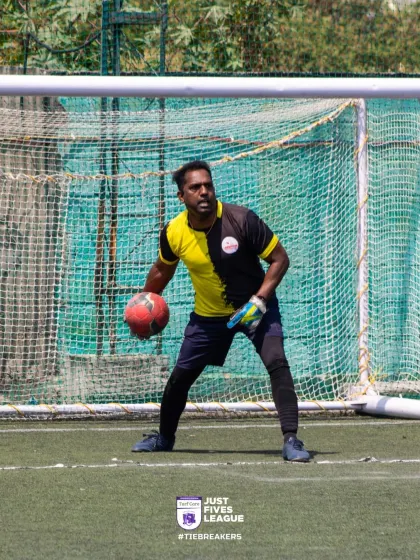 A goalkeeper confidently holds the ball, ready to start the next play. Their presence is a vital part of any successful team's defense.