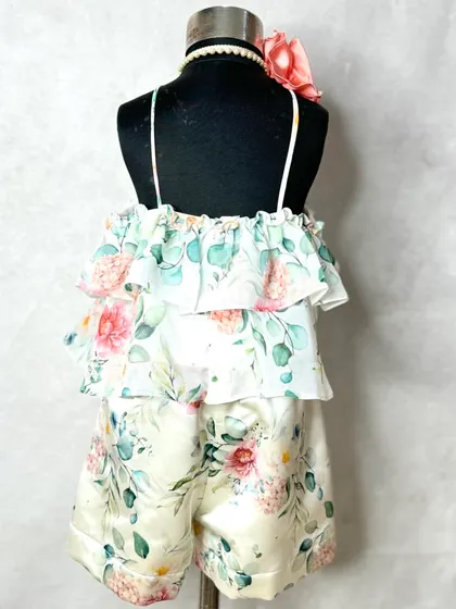 Summer vibes in a classic floral print. This set includes a tiered, ruffled halter top in floral georgette with matching shorts in Dutch satin.