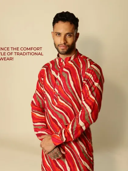 Experience the comfort and style of traditional Indian wear. This vibrant red and orange striped kurta is all about culture and making a bold statement.