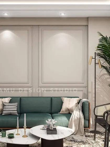 This Ghaziabad living room concept features a deep green sofa, rattan accent chairs, and classic wall molding. The design balances traditional elements with modern furniture for a timeless appeal.