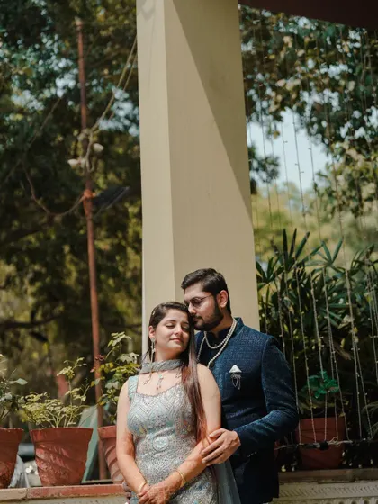 A quiet, romantic moment amidst the Mehendi celebrations. The couple shares an embrace outdoors, a peaceful pause in a day full of excitement.