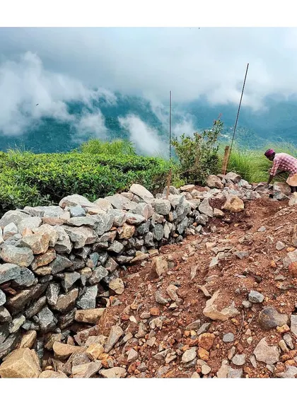 A craftsman builds a retaining wall using stone excavated directly from the project site. This practice of using local materials is central to my philosophy, ensuring the built structure is literally and figuratively grounded in its environment.