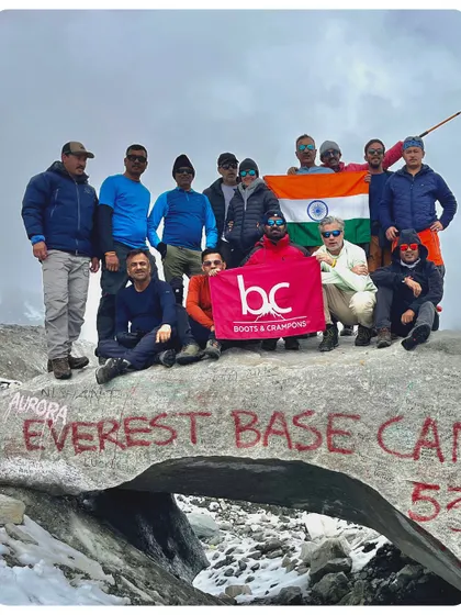 Our team celebrating at the EBC glacier, a natural arch of ice. This spot is a bit different from the main rock and offers a unique photo opportunity.