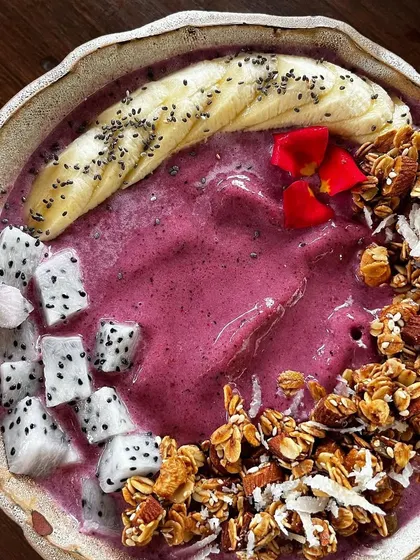 A vibrant smoothie bowl from Bloom & Brew, Goa. The beautiful colors and fresh toppings make this a perfect shot to attract health-conscious customers.