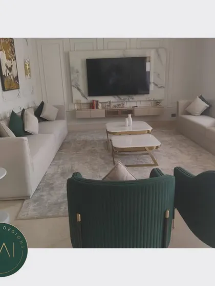 Another angle of the grand living room, showing the relationship between the seating areas and the marble-clad media wall. Our furniture is designed to complement and enhance the architectural features of a space.