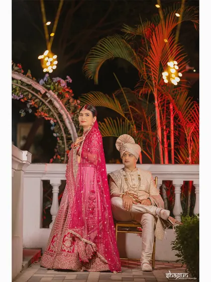 A regal portrait of the bride and groom. Her standing, him seated, creating a powerful and timeless image.