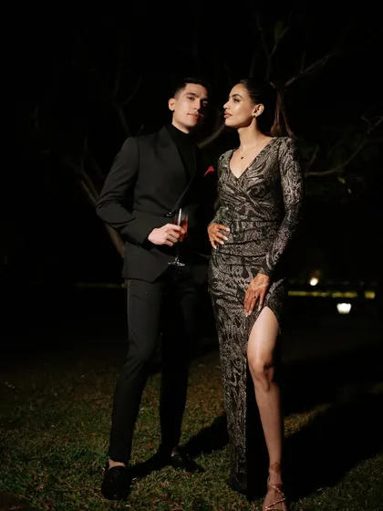 A powerful and stylish couple portrait. The bride's look is modern and sophisticated, perfect for a cocktail or reception event.