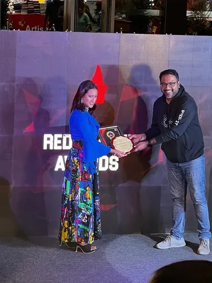 A clear shot of me accepting the Red Shakti Award for my work as a sports entrepreneur.