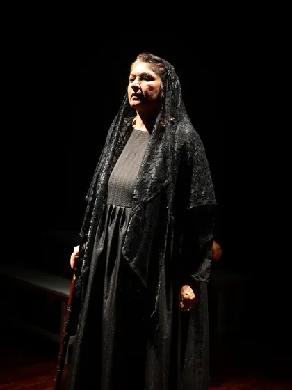 The formidable matriarch in "The House of Bernarda Alba." The play's dramatic lighting isolates characters, emphasizing the oppressive atmosphere of the household.