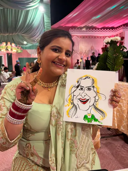 Peace, victory, and a whole lot of fun. This bride's friend is loving her caricature.