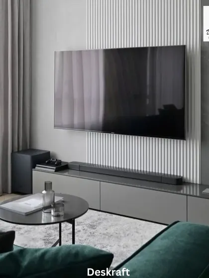 The view from the sofa towards the entertainment unit highlights the sleek, low-profile console and the textural contrast on the wall, embodying modern design principles.