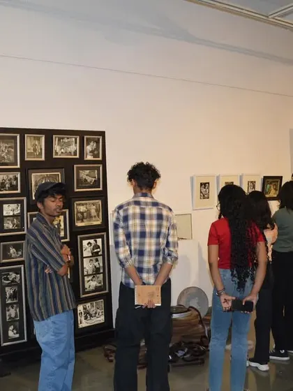 Students from ICAT Design & Media College looking at a display of vintage film stills and posters from 'Southern Stars'.