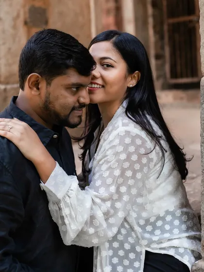 A playful, intimate moment with the bride-to-be whispering to her partner, capturing their secret jokes and close bond.