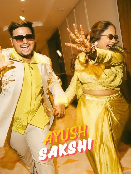 The couple's high-energy entrance, full of fun and personality. Their coordinated yellow outfits and joyful expressions make this a standout moment.