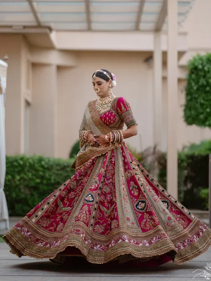 The perfect lehenga twirl. The volume and intricate work of this Marwar Couture creation are on full display in this classic bridal shot.