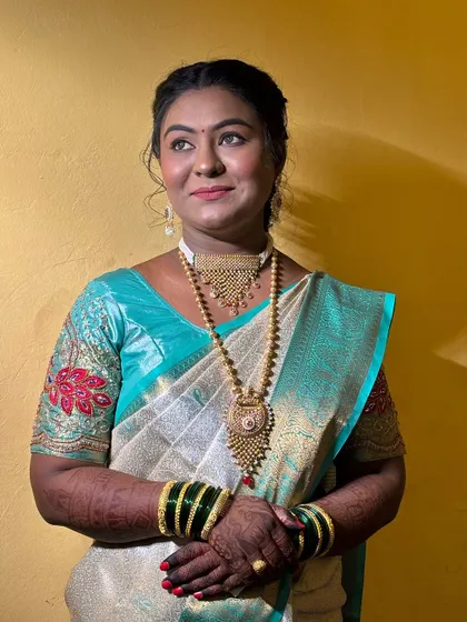 A profile shot showing the makeup and hairstyle in natural light.