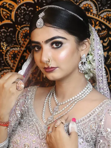 A close-up on the subtle smokey eye and perfectly defined features. This look is a testament to how balanced and beautiful modern bridal makeup can be.