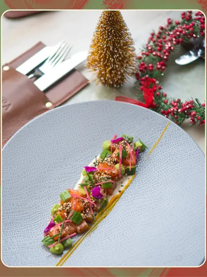 Our Cured Applewood Smoked Salmon, beautifully plated with festive decorations in the background. This dish was a light and refreshing starter on our holiday menu.