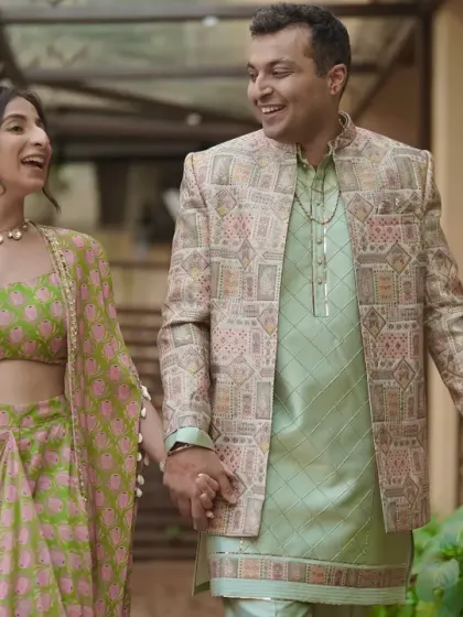 The happy couple walking hand-in-hand, smiling and laughing together.