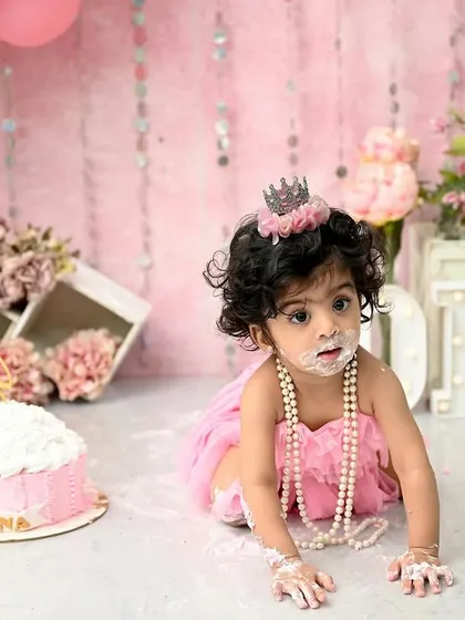 The pure, messy joy of a first birthday cake smash! This little princess is having the time of her life exploring her first taste of cake. These sessions are all about capturing candid happiness and personality.