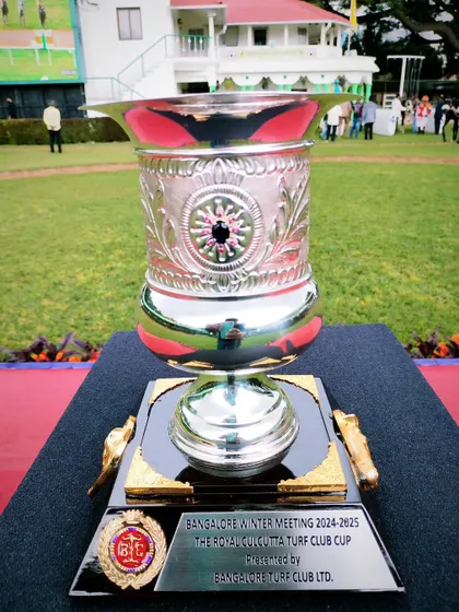 The Royal Calcutta Turf Club Cup, a grand silver trophy with detailed engravings.