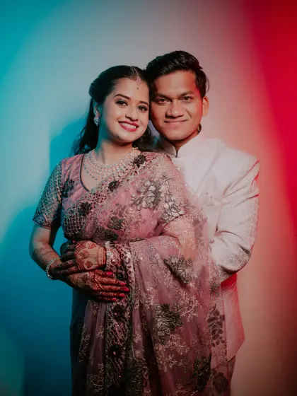 A stylish couple portrait using dual-tone red and blue lighting.