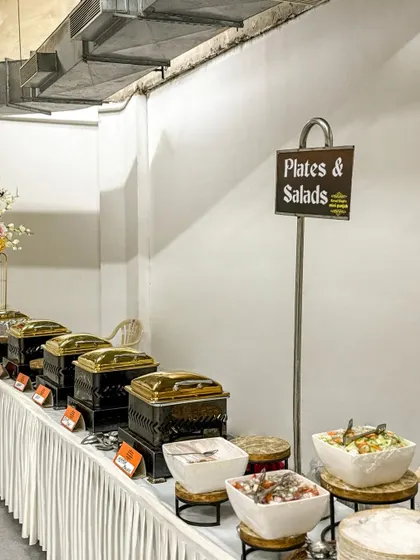 A full view of my plates and salads station. I offer a variety of fresh salads and accompaniments to complement the main courses, all presented in clean and modern serveware.