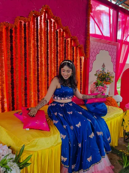Supritha looking stunning in her blue lehenga at her mehendi function, with her arms adorned in my designs.