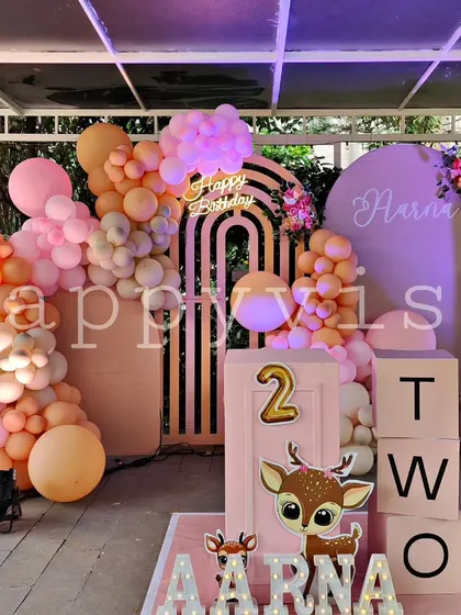 A soft and sweet woodland animal theme for Aarna's second birthday. The pastel color palette, cute deer cutouts, and modern arched backdrops create a gentle and charming atmosphere.