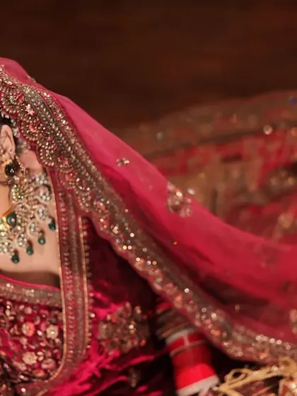 Capturing the timeless beauty of a bride. This high-angle shot showcases her intricate lehenga and the elegance of her pose.