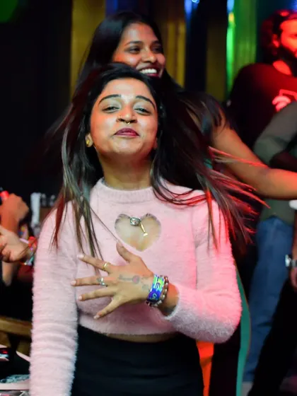 A guest dancing with her hair flying, feeling the beat. I play tracks that inspire freedom and joyful expression on the dance floor.
