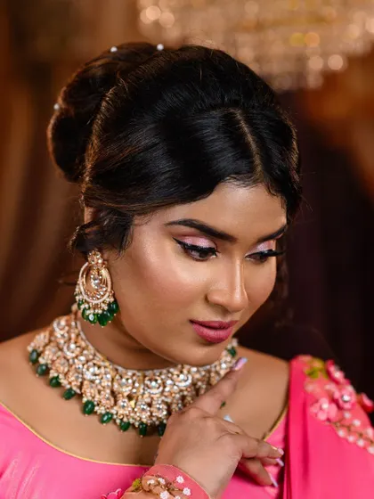 This shot beautifully captures the details of the elegant hair bun and the intricate design of the necklace and earrings, essential components for an authentic recreation.