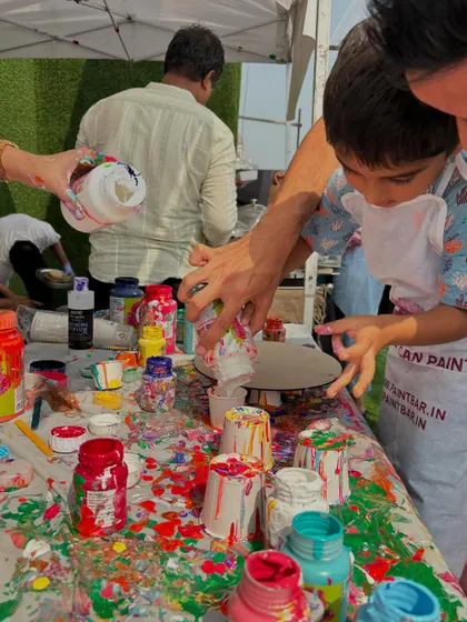 A young artist getting hands-on with paint pouring. These sessions are perfect for kids because there are no rules, just creative exploration.