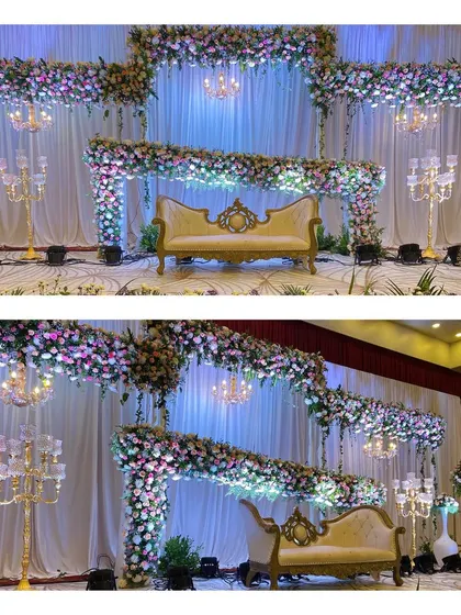 An elegant reception stage with flowing floral garlands, crystal candelabras, and delicate chandeliers. The soft, neutral color palette creates a timeless and sophisticated atmosphere.