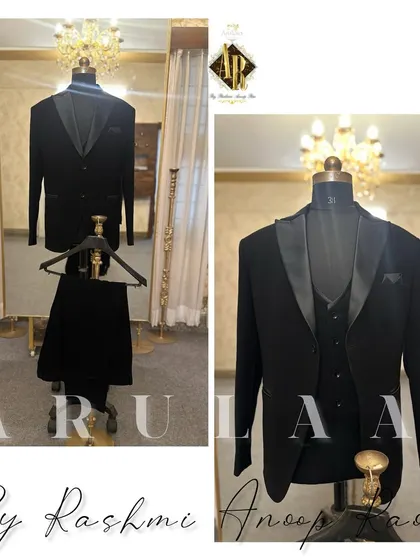 The quintessential black tuxedo. This three-piece suit is a masterpiece of tailoring, featuring satin lapels, a matching waistcoat, and a perfect fit that exudes confidence and style.