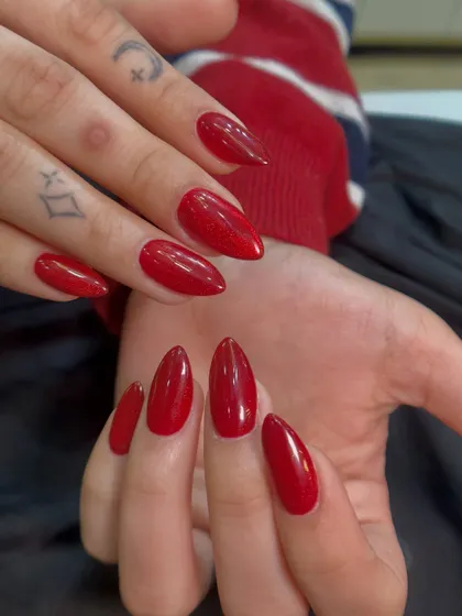 A close-up view where you can see the subtle shimmer within this red gel polish. It adds a little extra dimension to a classic color.