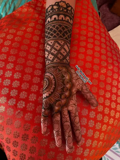 The front view of the bridal design with the elephant band, showing how it integrates with the palm's patterns.