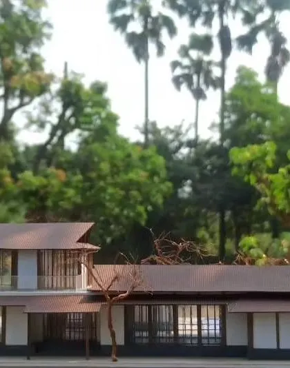 A physical model of a timber-framed house in Alibaug, showing how the design breaks the home into smaller pavilions connected by open corridors, all nestled amongst the trees.