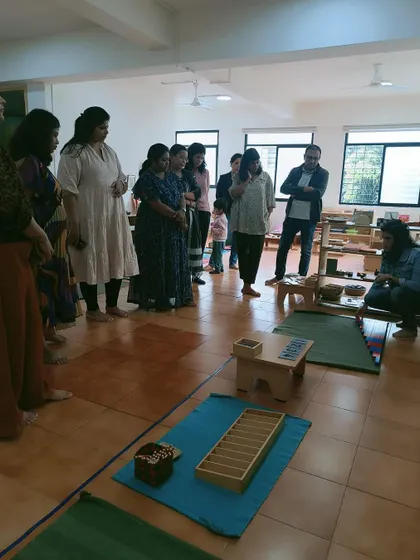 Parents observe a demonstration of Montessori materials. These sessions help them appreciate the depth and purpose behind each activity their child engages in.