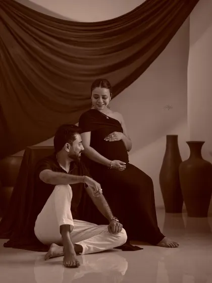 A classic sepia-toned couple's portrait. This timeless editing style adds a warm, nostalgic feel to the maternity photo.