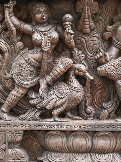 A close-up of an Apsara with a swan from the same panel, showcasing the fine details from her jewelry to the feathers of the bird. Each element is carefully carved to contribute to the overall narrative.