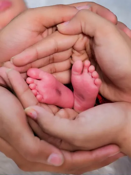 It’s all in the tiny details. A newborn's feet, so small and perfect, held safely in their parents' hands. This is one of the most requested shots in my newborn family sessions, a simple and powerful symbol of new life.