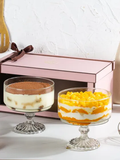 The Mango Cream Cheese and Tiramisu trifles displayed outside their pink twin gift box, showing the beautiful pairing.