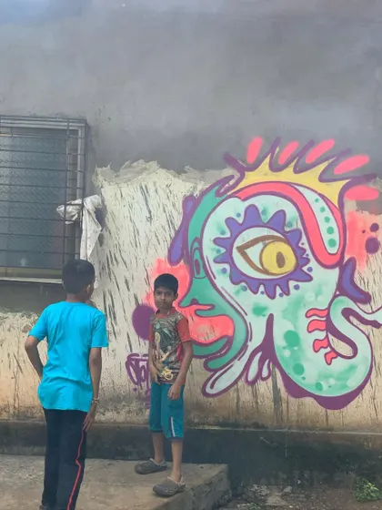 This is my 'psyganesh' character, a psychedelic interpretation of Ganesha. It's a way for me to connect my spiritual side with my street art style, watched by some local kids.